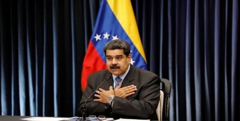 Venezuela's President Nicolas Maduro gestures as he talks to the media during a news conference at Miraflores Palace in Caracas, Venezuela, Sept. 18, 2018.  Pho