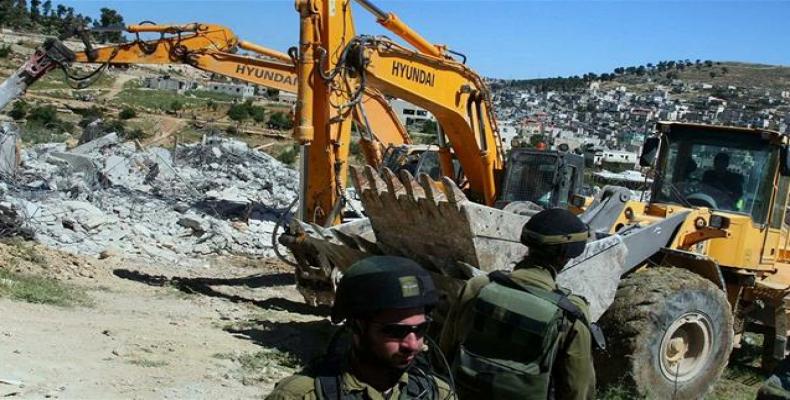 Israeli bulldozers can be seen destroying Palestinian homes in the occupied West Bank.  Photo: File