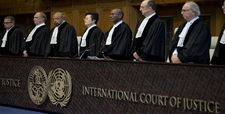 Judges enter the International Court of Justice, or World Court, in The Hague, Netherlands, Wednesday, Oct. 3, 2018, where they ruled on an Iranian request to o