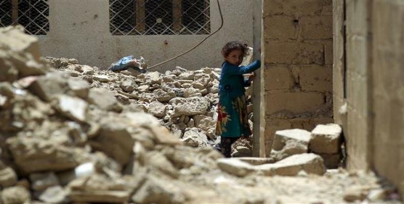 A little girl stands amid the ruins of a building destroyed in airstrikes on Yemen (Photo by AFP)