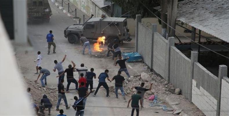 Protesters throw stones and Molotov cocktails at Israeli forces in the village of Shuwaykah in the occupied West Bank.  Photo: AFP