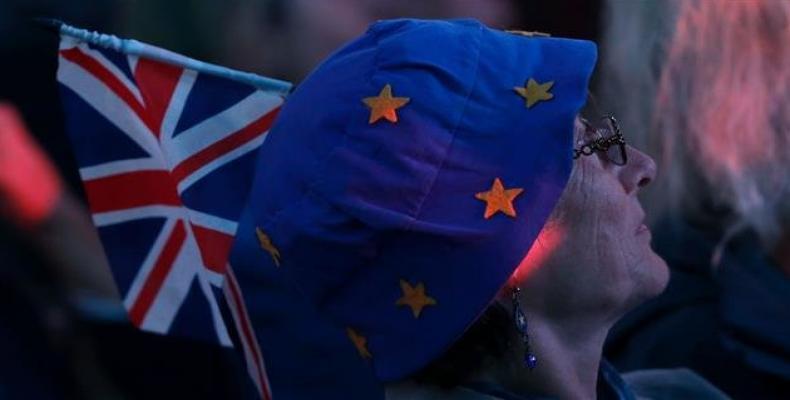An anti-Brexit, pro-European Union (EU) supporter, wears an EU themed-hat and a Union flag as she attends a ceremony in Dover, England, to launch a nationwide c
