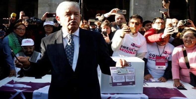 Mexico's President-Elect Andres Manuel Lopez Obrador talks to reporters before casting his vote in a public consultation on the fate of a $13.3 billion USD Mexi