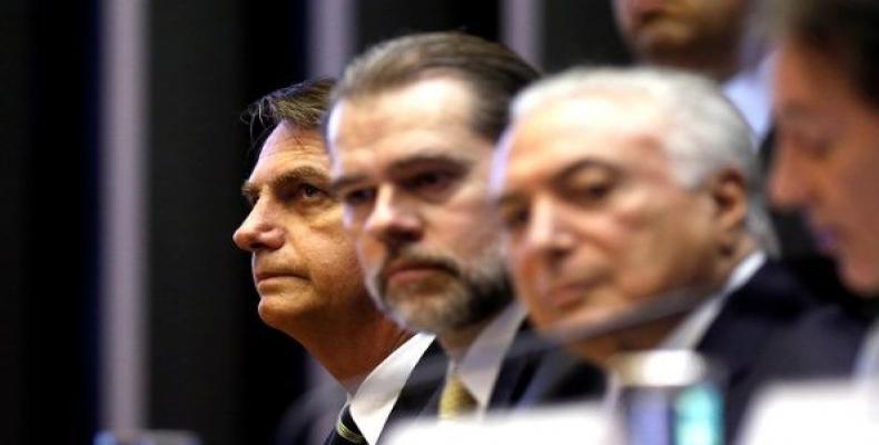 Brazil's President-elect Jair Bolsonaro (L), President of Brazil's Supreme Federal Court Dias Toffoli (C) and Brazil's President Michel Temer attend a session a