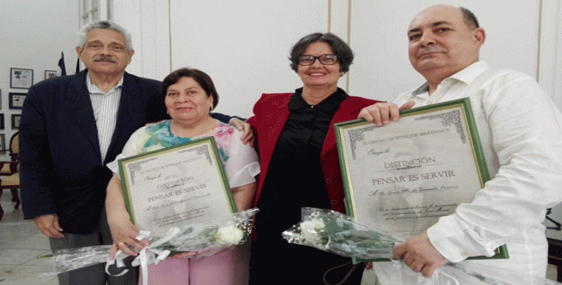 Los especialistas del CEM, Dr. Pedro Pablo Rodríguez (I) y Marlene Vázquez (segunda de derecha a izquierda) entregan el reconocimiento. Foto: PL