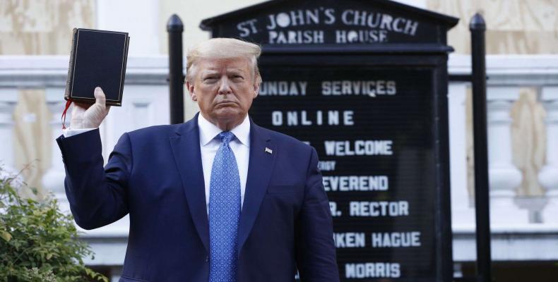 President Donald Trump holds a Bible as he visits outside St. John's Church across Lafayette Park.  (Photo: AP)