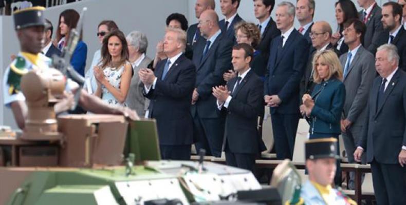 This file photograph taken on July 14, 2017 shows French President Emmanuel Macron and US President Donald Trump, among other spectators, as they attend the an