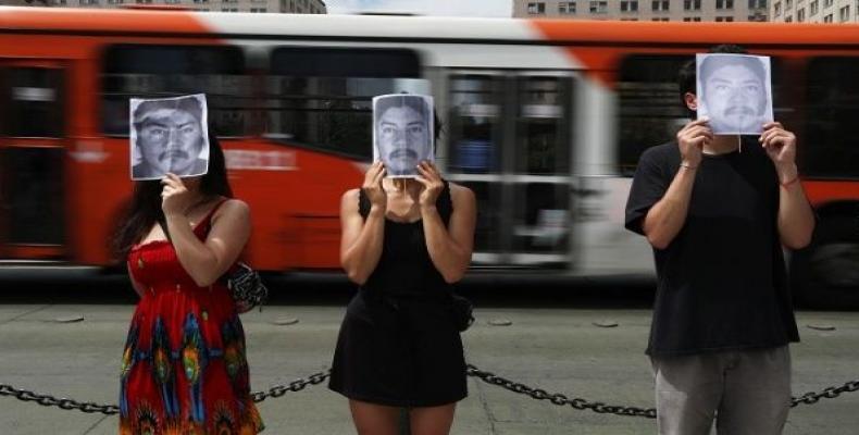 Demonstrators hold images of Camilo Catrillanca, an indigenous Mapuche man who was shot in the head during a police operation in 'Ercilla' town south of Santiag