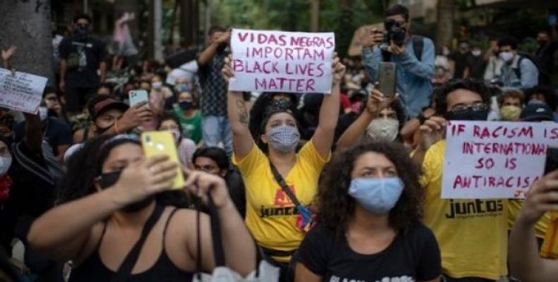 The teenager’s killing comes as tens of thousands of Brazilians joined the international protests. (Photo: AFP)