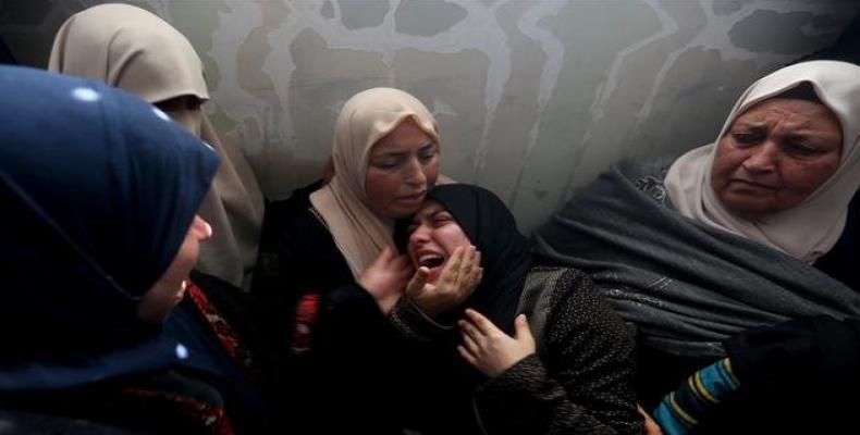 Relatives of Palestinian teen Hassan Iyad Shalabi, 14, killed during a protest at the border fence between the Gaza Strip and the Israeli-occupied territories,