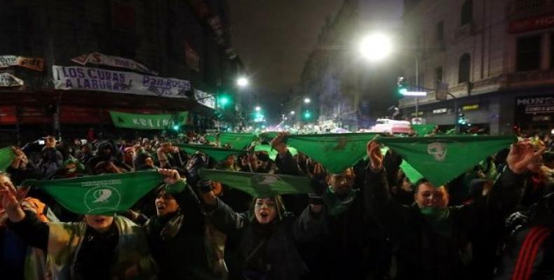 Activists hold up green handkerchiefs outside the Congress after senators rejected a bill to legalize abortion in Buenos Aires.  Photo: Reuters