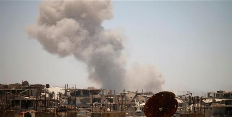 Smoke rises above the Syrian southwestern city of Dara’a on June 25, 2018.  Photo: AFP