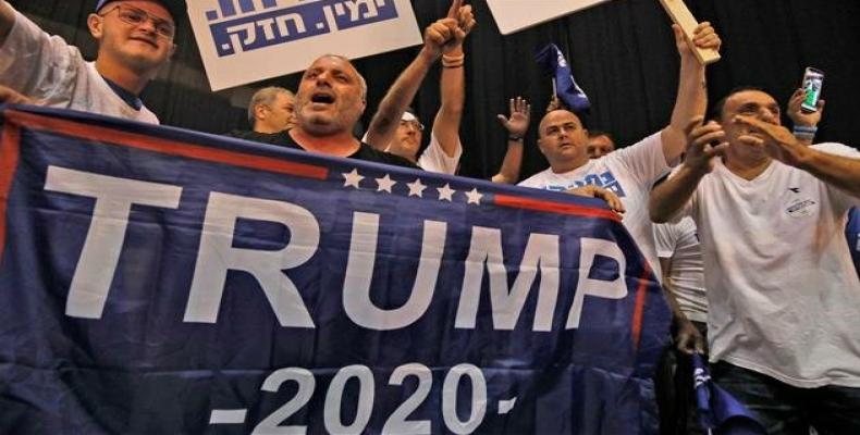 Israeli Likud party supporters wave a Trump 2020 electoral banner.  (Photo: AFP)