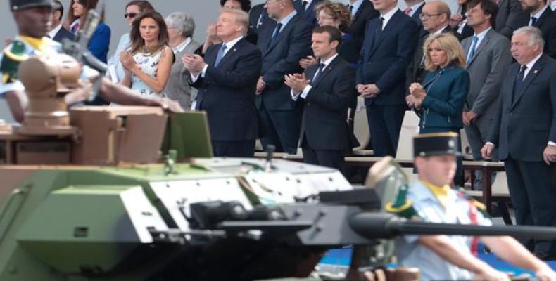 Tanks parade past (L-R) US President Donald Trump, first lady Melania Trump, French President Emmanuel Macron, and his wife, Brigitte Macron, during a Bastille