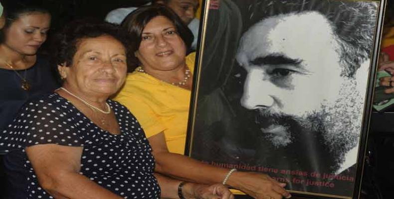 Delsa Esther Puebla (I) y Arelys Santana (D) exhiben con orgullo la foto del Comandante en Jefe Fidel Castro. Fotos: PL