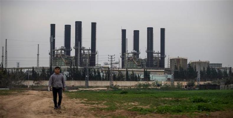 A Palestinian boy walks back from the Gaza Strip's sole electricity plant on February 15, 2018.  Photo by AFP