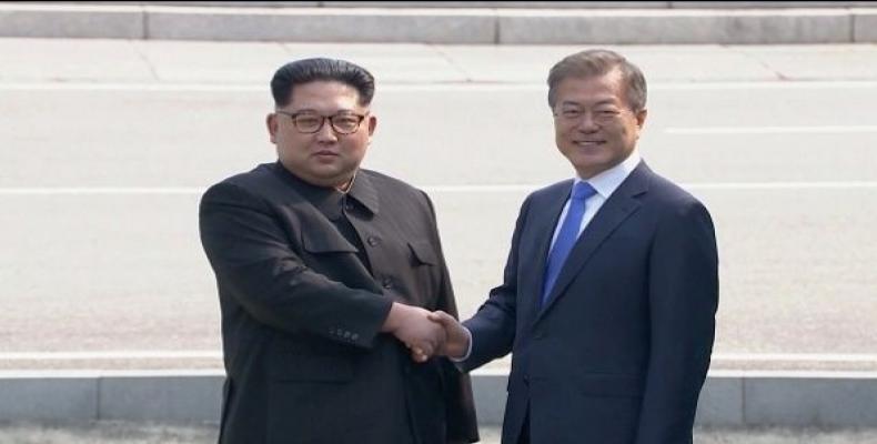 South Korea's Moon greeted Kim at the military demarcation line, making Kim the first North Korean leader to set foot in the South since the 1950-53 Korean War.