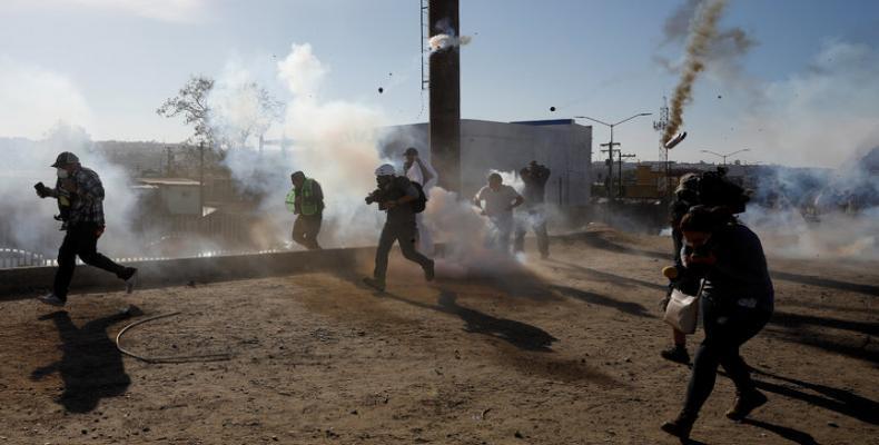 Migrant families tear gassed on U.S. border with Mexico.  Photo: Reuters