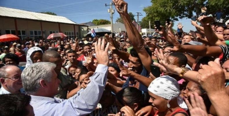 Cuban president Miguel Diaz-Canel is by local residents in Santiago de Cuba. 