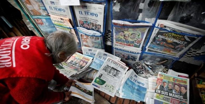 A woman sells newspapers that show candidates Gustavo Petro and Ivan Duque go to the second round of presidential election, in Bogota, Colombia May 28, 2018.  P