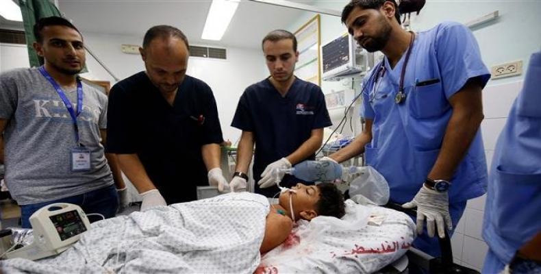 Palestinian minor Youssef Abu Zarifa, wounded during clashes along the border between the Gaza Strip and Israeli-occupied territories, receives treatment at a h