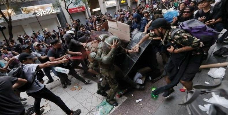 Mapuche activists are attacked by Carabineros while demanding justice for Camilo Catrillanca, shot in the head by Carabineros. Santiago, Chile Dec. 27, 2018