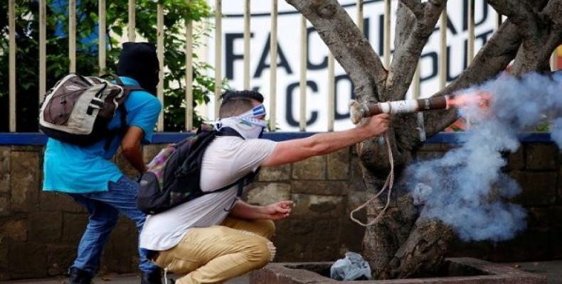 Nicaraguan protester fires homemade mortar at riot police.  Photo: Reuters