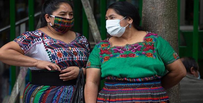 Indigenous women wearing masks to prevent the spread of the new coronavirus stand near the National Palace in Guatemala City.  (Photo: Moises Castillo/Reuters)