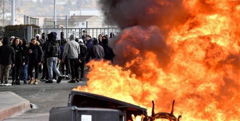 Students burn a barricade in front of their high school during a demonstration against education reforms on December 4, 2018 in Bordeaux, southwestern France.