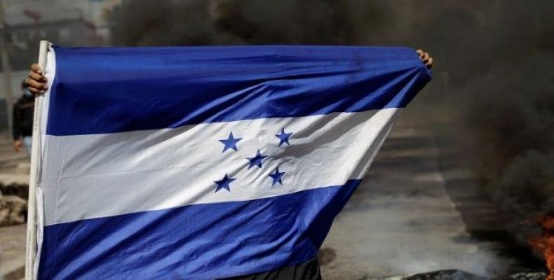 A demonstrator holds a Honduran flag during a protest against Honduran President Juan Orlando Hernandez and his government in Tegucigalpa, Honduras, Jan 27, 201