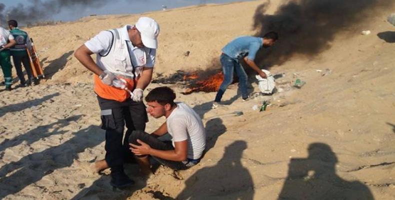 The picture shows medics treating injured Palestinian protesters on the Gaza beach.  Photo: via social media
