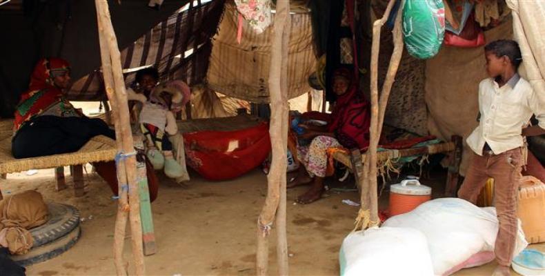 Displaced Yemenis from Hudaydah sit in their shelter at a makeshift camp for displaced people in the northern district of Yemen's Hajjah province on June 19, 20