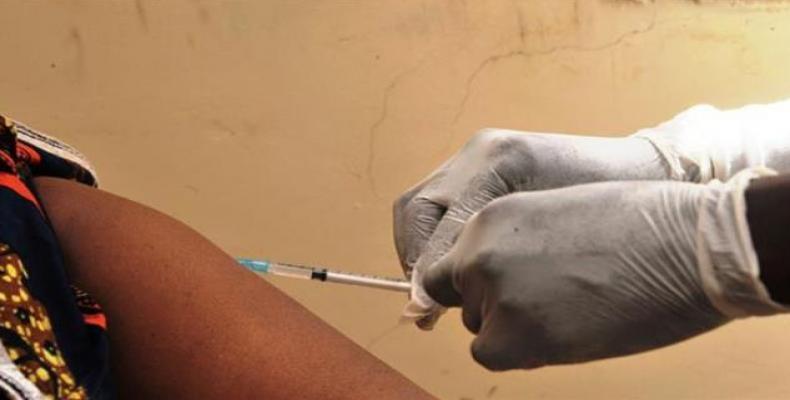 This file photo taken on March 10, 2015 shows a woman getting vaccinated at a health center in Conakry during the first clinical trials of the VSV-EBOV vaccine