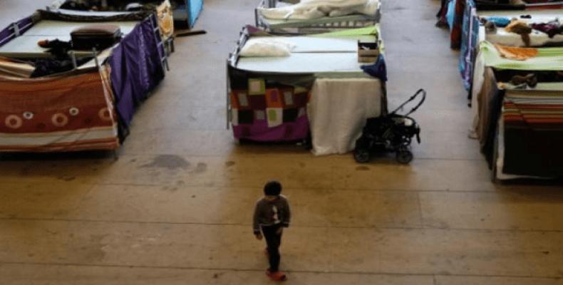 A migrant child in the sports hall at Jane-Addams high school, which has been transformed into a refugee shelter in Berlin, Germany.  Photo: Reuters