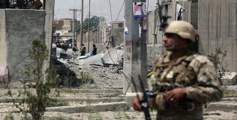 An Afghan security personnel stands guard at the site where a Taliban car bomb detonated.   (Photo by AFP)