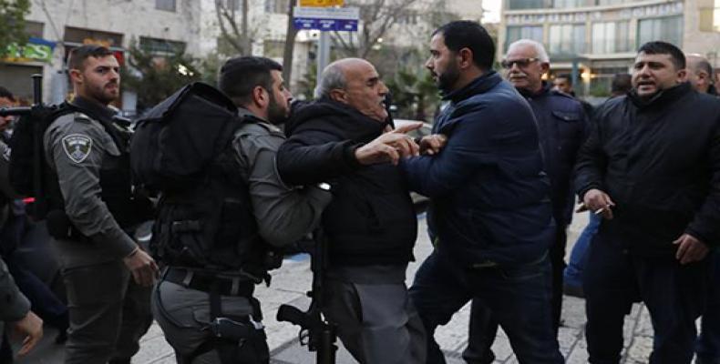 Israeli forces restrain a Palestinian protester during a small protest in East Jerusalem al-Quds on December 30, 2017. (Photo by AFP)