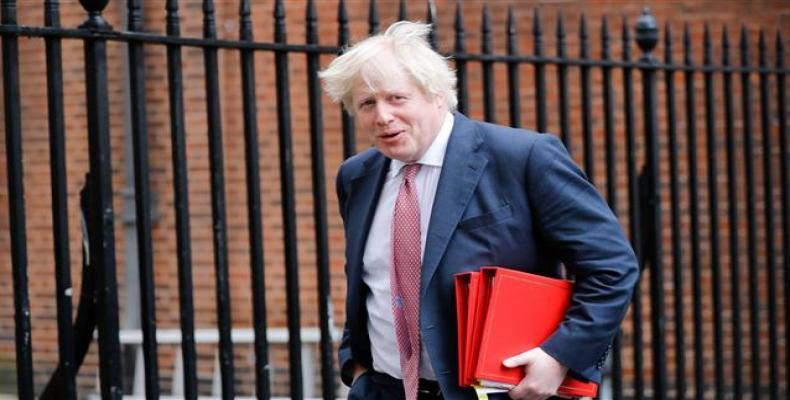In this file photo taken on March 27, 2018 Britain's former foreign secretary Boris Johnson leaves 10 Downing Street in central London after attending the weekl