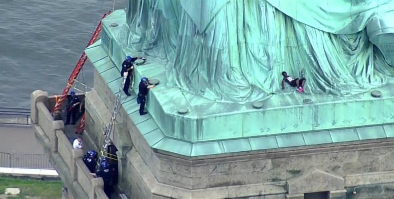 Protesters climb Statue of Liberty on 4th of July.  Photo: AP