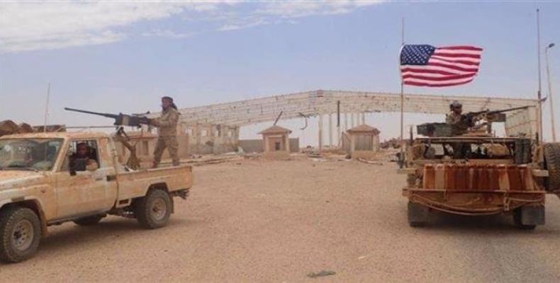 In this file picture, a US-backed Takfiri militant mans a heavy automatic machine gun (L) next to an American soldier as they take their positions at the al-Tan