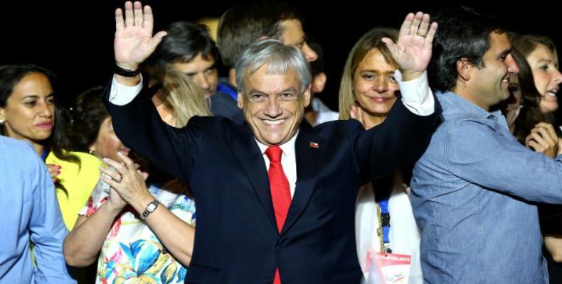 Presidential candidate Sebastian Pinera waves to supporters after winning the election  (Reuters)