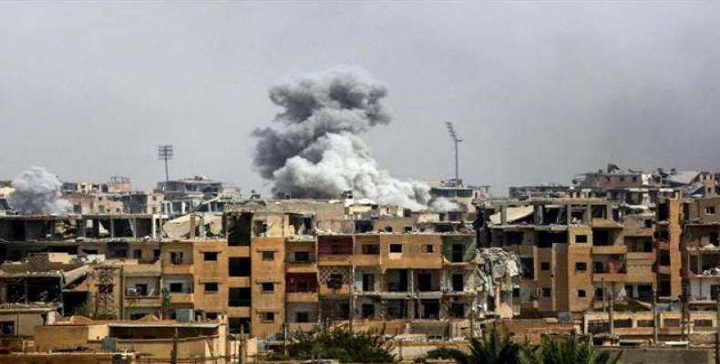 This photo taken on September 5, 2017, shows smoke billowing out following a US-led coalition airstrike in the western al-Daraiya neighborhood of the embattled