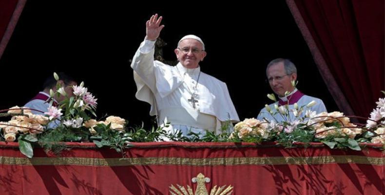 Pope Francis greets the crowd  from the central balcony of St. Peter's Basilica, December 25, 2017