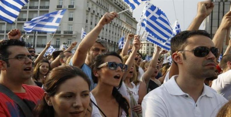 This file photo shows protesters shouting slogans during a rally against austerity economic measures and corruption in front of parliament in Athens, Greece.  P
