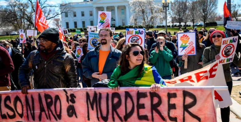 American and Brazilian activists protest against the upcoming visit of Brazilian president Jair Bolsonaro, before the White House. Photograph: Eric Baradat/AFP