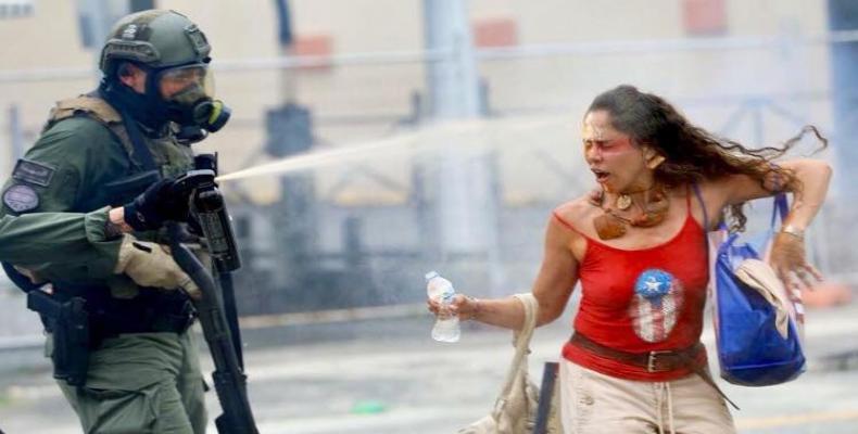 Puerto Rican police fire tear-gas at young protesters.  Photo: AP