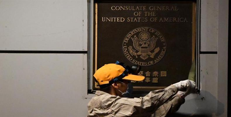 A worker removes the plaque on the wall outside the U.S. consulate in Chengdu.  (Photo: Noel Celis/AFP)
