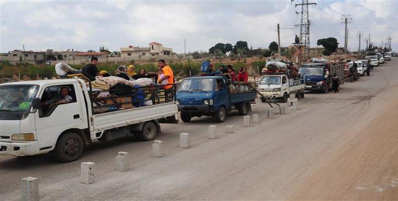 This handout picture released by the official Syrian Arab News Agency, SANA, on July 29, 2018, shows displaced Syrians returning to their villages in the provin