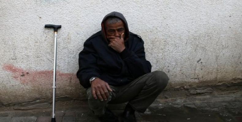 A relative waits outside a hospital morgue after two Palestinians were killed in Rafah in the southern Gaza Strip February 18, 2018.  Photo: Reuters