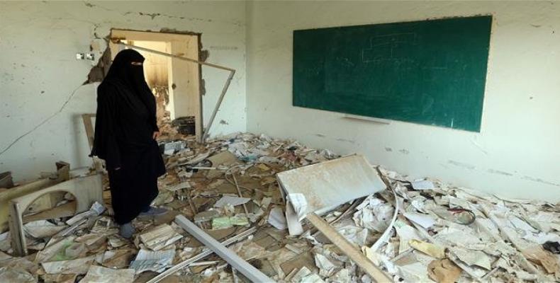 File photo shows a Yemeni woman inspecting the damage on the first day of the new academic year on September 16, 2018, at a school that was damaged last year in