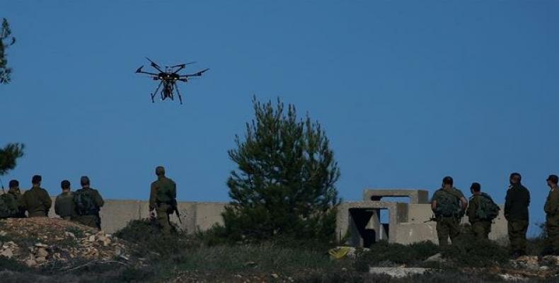 Israeli soldiers with drone prepared to throw gas canisters during clashes with Palestinian protesters in Ramallah.  (Photo by AFP)